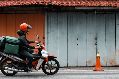 Man riding motorcycle on road