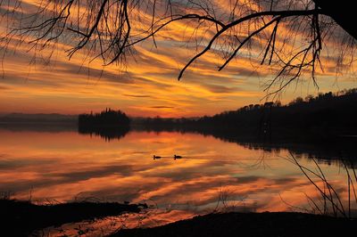 Scenic view of lake against orange sky