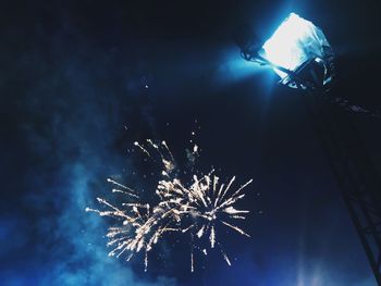 Low angle view of fireworks in sky at night