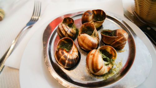 High angle view of cooked seashells in plate on table