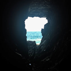 Scenic view of sea seen through arch