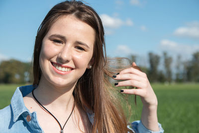 Portrait of smiling young woman holding flower