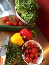 High angle view of tomatoes and vegetables on table