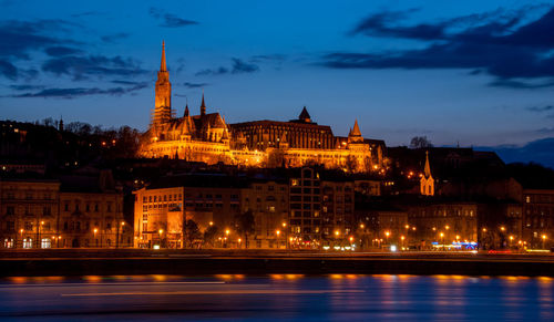 Royal palace or the buda castle and the chain bridge after sunset 
 in budapest hungary.