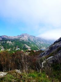 Scenic view of mountains against cloudy sky