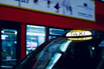 Close-up of illuminated taxi sign