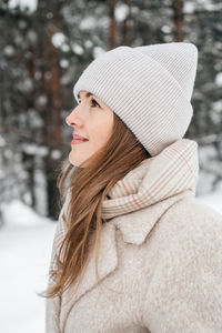 Portrait of a girl in warm clothes in a winter forest. high quality photo