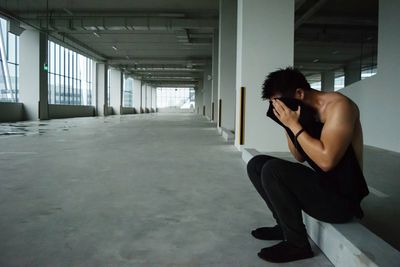 Man wiping face after exercise