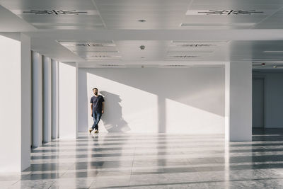 Man walking in corridor of building