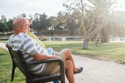 Man sitting on seat in park