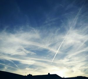 Low angle view of vapor trail in blue sky