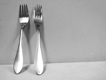 Close-up of forks against wall