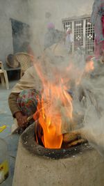 Midsection of woman with fire