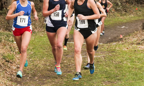 Group of people running on grassland
