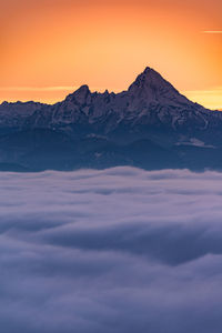 Scenic view of snowcapped mountains against sky during sunset