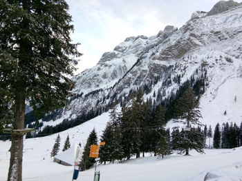 Scenic view of snow covered mountains against sky