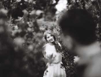 Smiling young bride looking groom