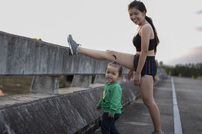 Full length of young woman exercising on staircase