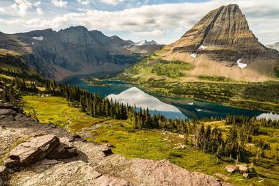 Scenic view of lake and mountains against sky