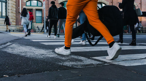 Low section of people walking on road