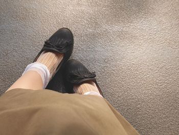 Low section of womans footstep on concrete floor