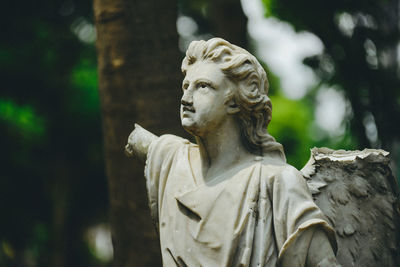 Statue against tree