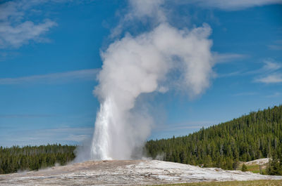 Panoramic view of waterfall against sky