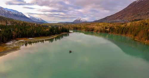 Scenic view of lake and mountains against sky