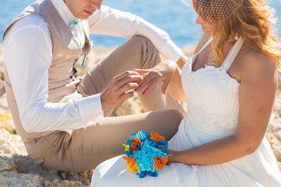 Rear view of couple holding hands