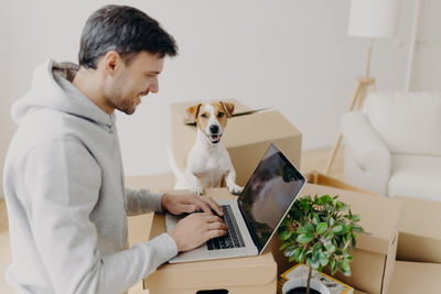 Man using laptop at new home