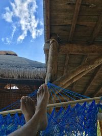 Low section of person relaxing on hammock