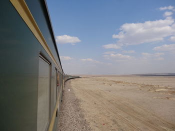 Train by landscape against sky