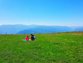 Scenic view of mountains against blue sky