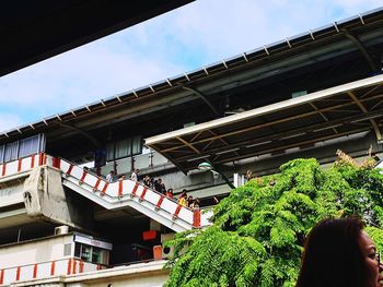 Low angle view of woman against building