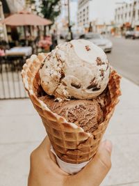 Close-up of hand holding ice cream cone