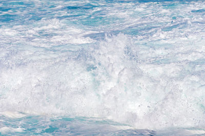 Wave crush with splashes and white foam nature background, texture