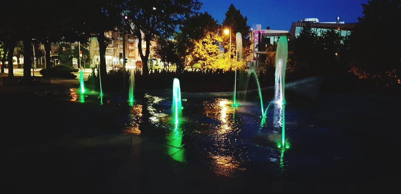 VIEW OF ILLUMINATED BUILDINGS AT NIGHT