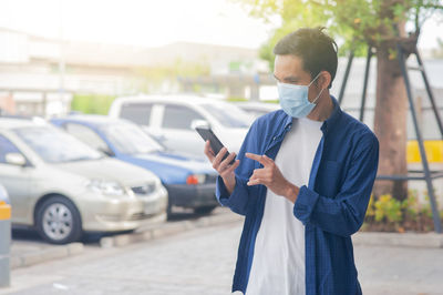 Man using mobile phone while standing on street