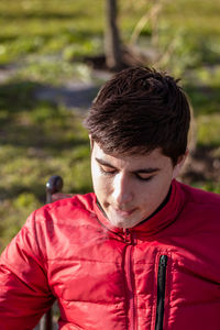 Close-up portrait of young man wearing red outdoors
