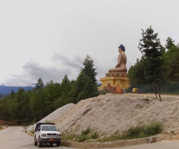 Statue of buddha against trees