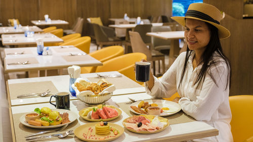 Portrait of young woman having food