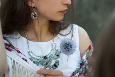 Midsection of woman wearing necklace