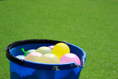 Close-up of multi colored ball in container