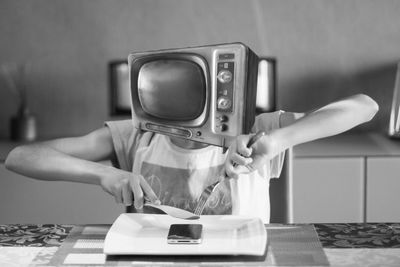 Television covering face with mobile phone in plate