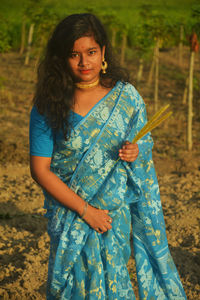 Portrait of smiling woman standing on land