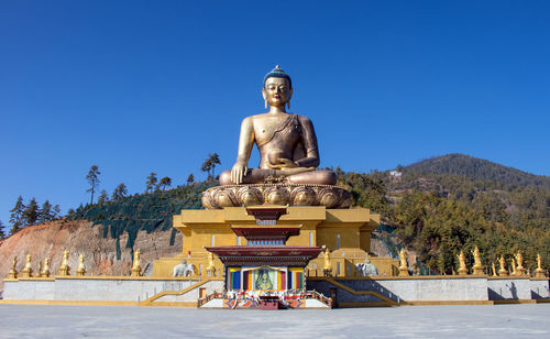 Statue of temple against blue sky
