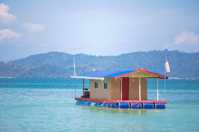 Built structure in sea against sky