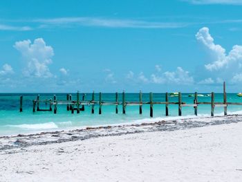 Scenic view of beach against blue sky