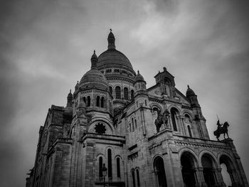 Low angle view of cathedral against cloudy sky