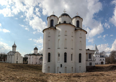 Low angle view of bell tower against cloudy sky